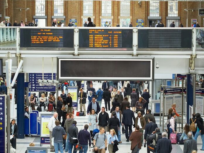 People walking through a train station