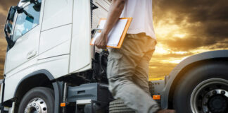 Truck transportation, truck driver walking around semi truck inspecting and safety check before driving a truck
