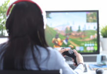 Woman with remote control in hands playing video game