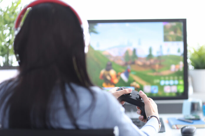 Woman with remote control in hands playing video game