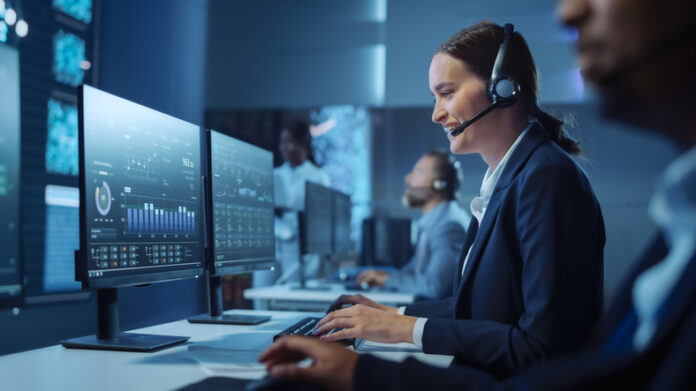 Technical Customer Support Specialist Having a Headset Call while Working on a Computer