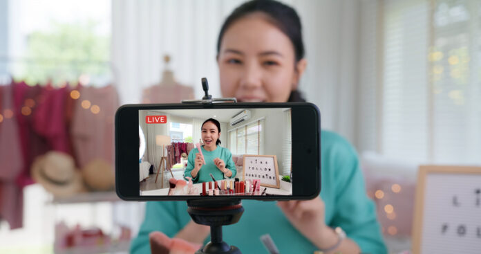 Businesswoman live streaming her make up product