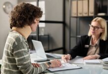 Young woman with neck injury filling documents