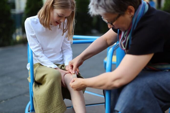 Young girl in pain after a playground injury