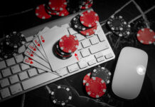 Online Casino. Poker chips lie on the keyboard.