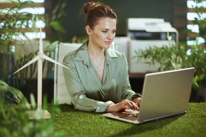 Pensive elegant business woman in green office working