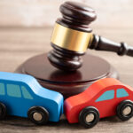 Hammer gavel judge with car vehicle accident, insurance coverage claim lawsuit court case