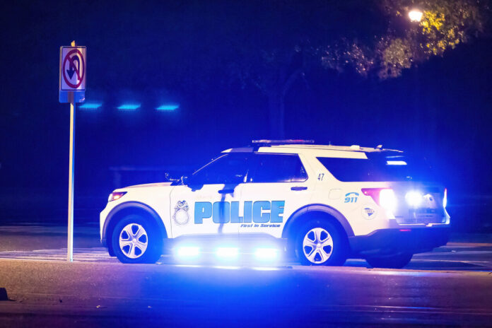 Flashing lights police car at night at road scene