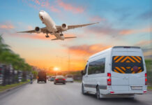 Mini bus drives along the highway among other cars in the evening in the sunset sky