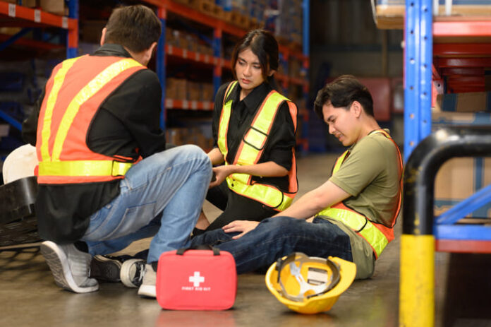 Male worker has an accident on the floor in warehouse site