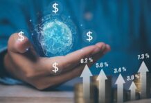 Businessman holding global with currency icon (dollar, euro, pound, and ruble) with coins stack