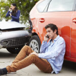 Teenage Driver Making Phone Call After Traffic Accident