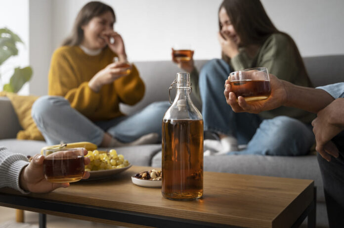 People drinking kombucha at a gathering