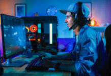 Professional Gamer Playing First-Person Shooter Online Video Game on His Powerful Personal Computer