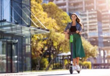 Female commuter riding electric push scooter