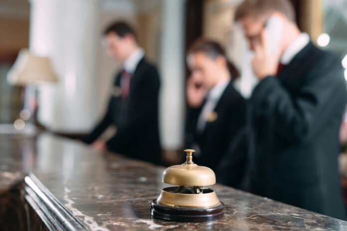 Hotel service bell at reception counter desk