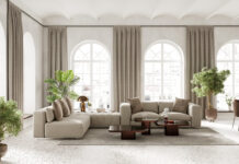 Large living room inderior with arch windows, furnished with modern sofa and dining table