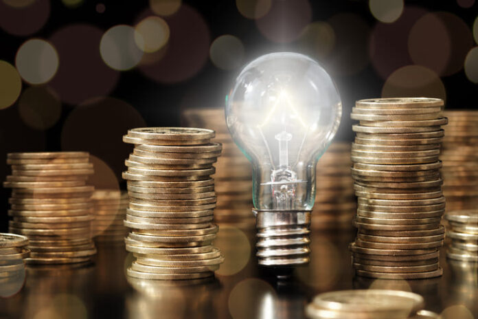 Lightbulb and stack of coins