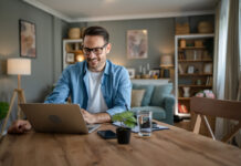 One man adult caucasian work on laptop at home happy smile