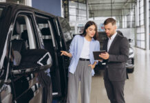 Lady Buyer Standing In Luxury Automobile Dealership Store.