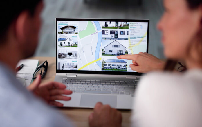 Family Searching Real Estate Online On Laptop