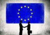 Two Business Person Shaking Hands with the European Union Flag