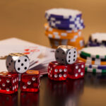 set of playing card with dices on reflective table