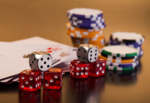 set of playing card with dices on reflective table