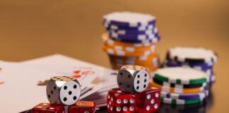 set of playing card with dices on reflective table