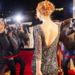 Celebrity leaving and being photographed by paparazzi photographers at red carpet event