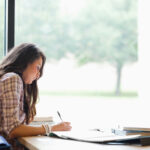 Gorgeous student studying in the library