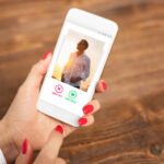 Woman using dating app and swiping user photos