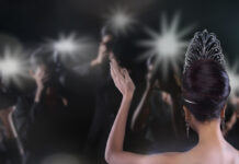 Back side view of Miss Pageant beauty contest with Silver Diamond Crown wave hand to many Photographers