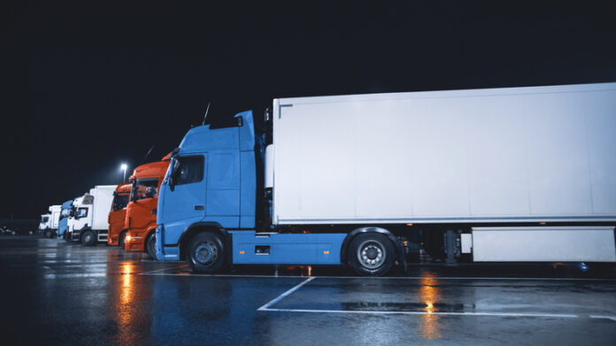 Line of Semi-Trucks with Cargo Trailer Drives Standing on the Overnight Parking Place