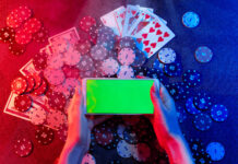 Playing cards, betting Chips and a smartphone with a copy space in women's hands