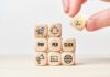 Person stacks wooden cubes from text and icons