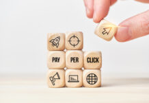 Person stacks wooden cubes from text and icons