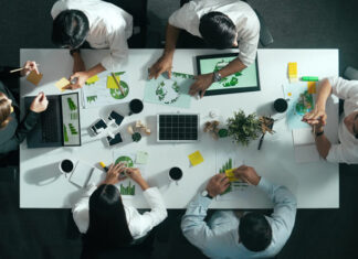 Top down view of business team discussing about using clean energy and sustainable investment at meeting table