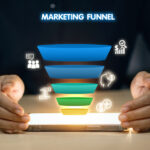 A person is holding a tablet with a marketing funnel on it