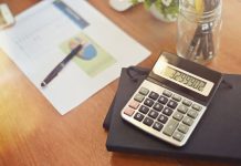 calculator and notebook on office desk