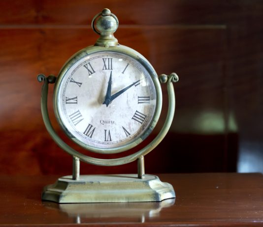 Vintage clock on the table in the bedroom