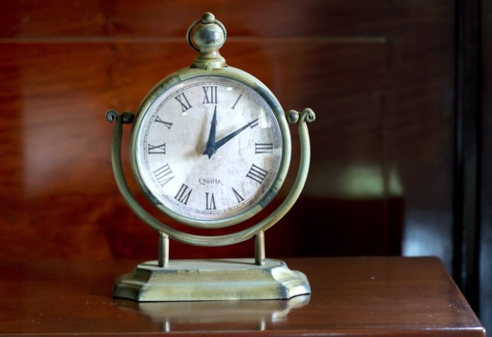 Vintage clock on the table in the bedroom