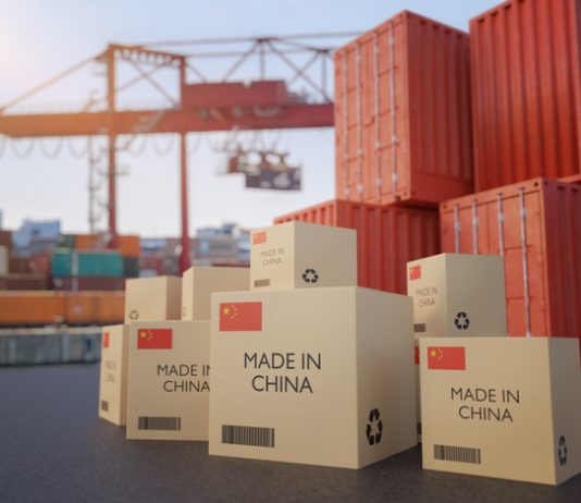 Many chinese cargo containers and cardboard boxes. Importing goods from China