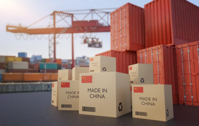 Many chinese cargo containers and cardboard boxes. Importing goods from China