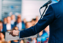 Politician speaking to the crowd from stage