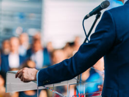 Politician speaking to the crowd from stage