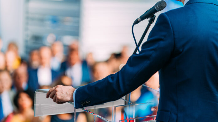 Politician speaking to the crowd from stage