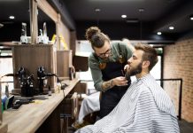 Client during beard shaving in barber shop