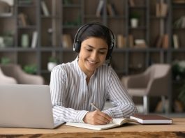 Happy beautiful Indian woman studying on online courses