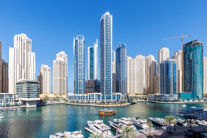 Dubai Marina skyline cityscape with yachts skyscraper buildings living at water